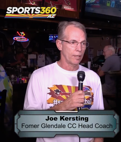 Joe Kersting speaking into a microphone during a television interview.